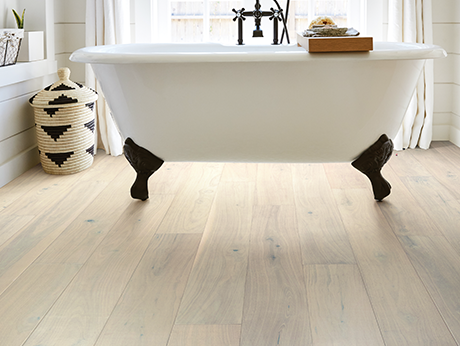 standalone white tub on waterproof flooring